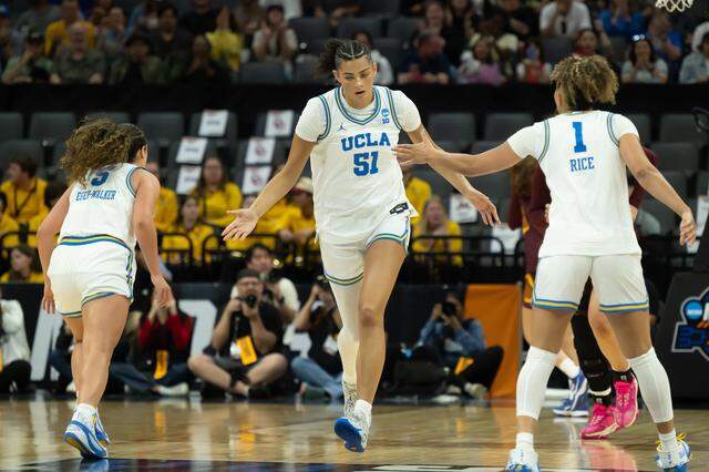 UCLA Bruins center Lauren Betts (51) reacts after scoring a basket with guard Kiki Rice (1) during the NCAA Women’s Basketball Tournament Sweet 16 game at Golden 1 Center in Sacramento on Friday.